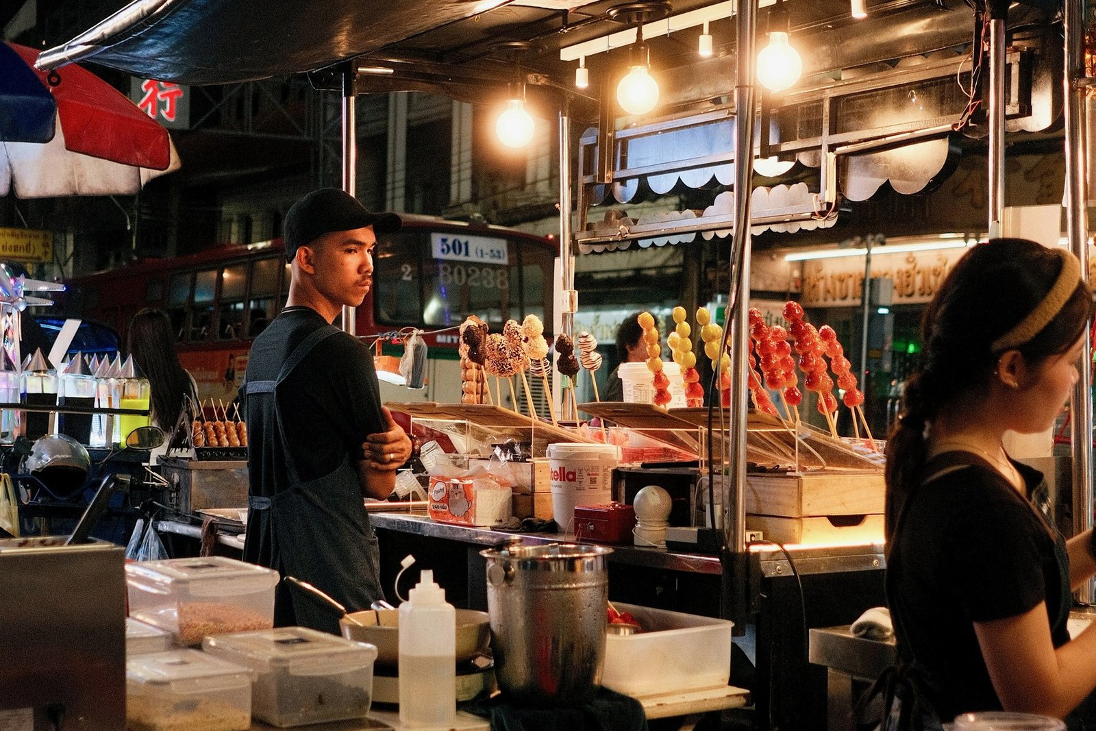 A brightly lit night-time street-food stall in Bangkok Chinatown on Yaowarat Road.